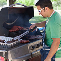 An image of a man grilling snacks at a corporate fun event.