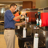 An image of a man dispensing snacks at a corporate fun event.