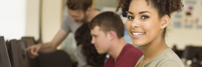 A banner of an image of students working in a computer lab.