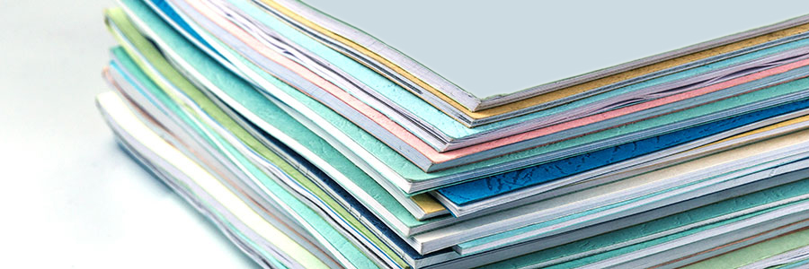 A banner of an image of a stack of research documents.