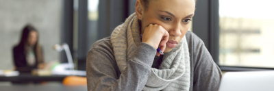 A banner of an image of a young woman studying on her laptop.
